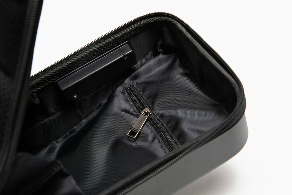 Open cosmetic organization case showing neatly arranged makeup brushes, compacts, and lipsticks