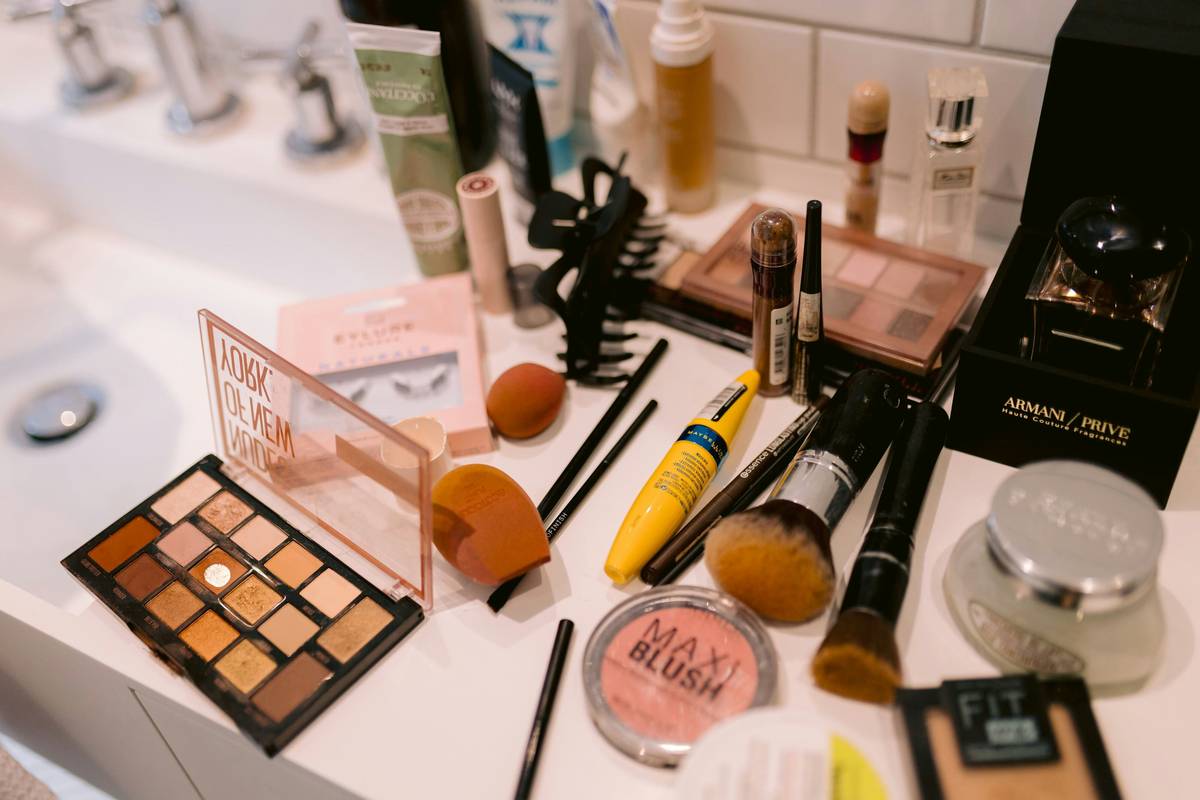 Clear acrylic makeup organizer solution with labeled compartments for brushes, palettes, and liquids